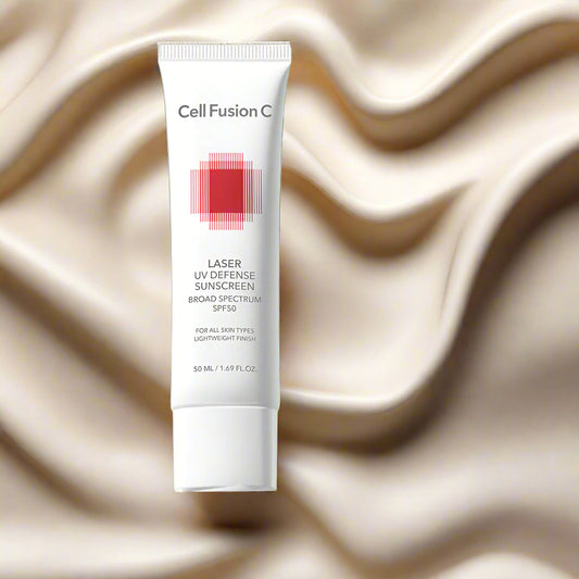 Tube of Cell Fusion Laser UV Defense Sunscreen on a red background